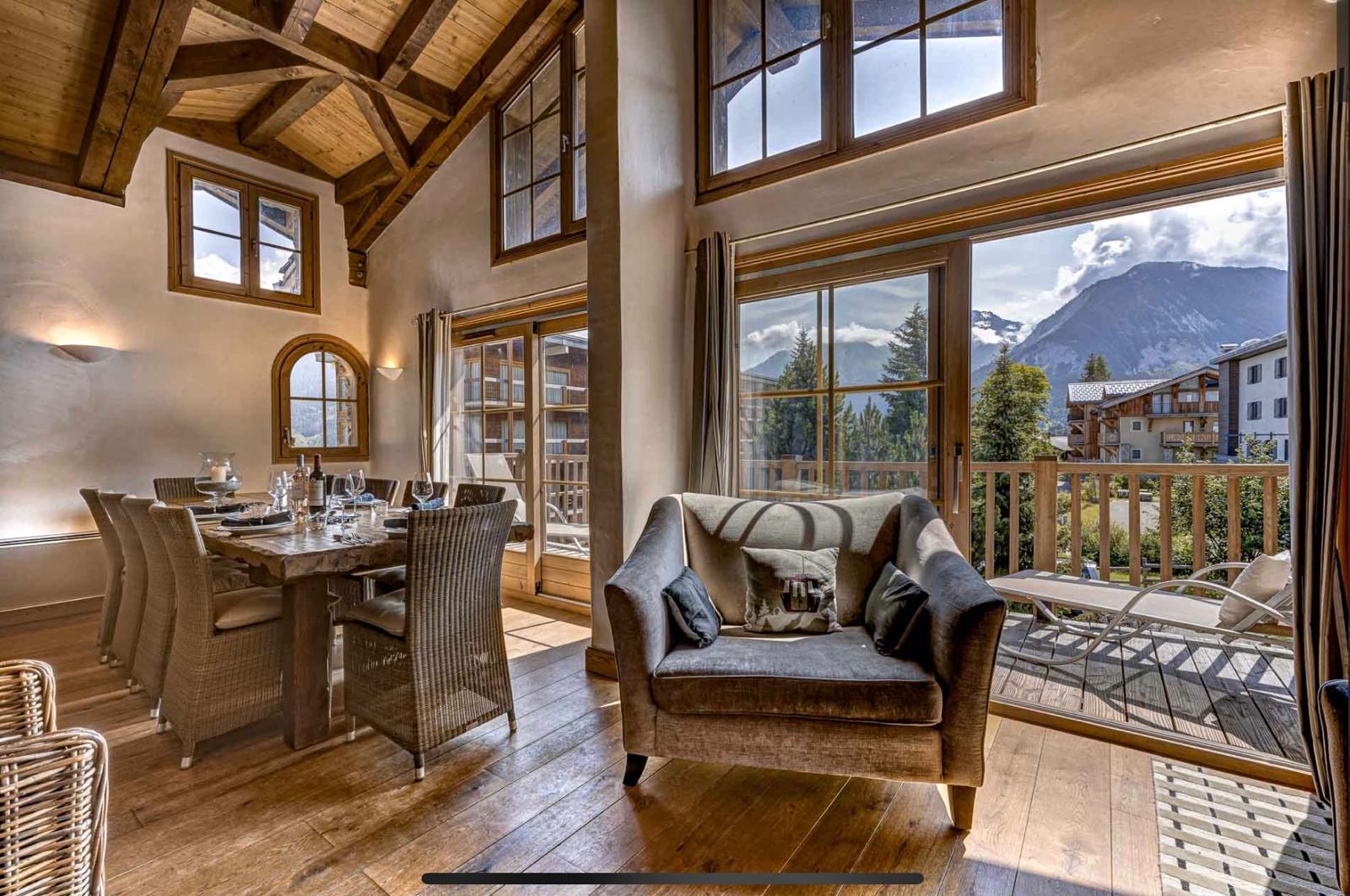 Open plan apartment living and dining area with mountain views