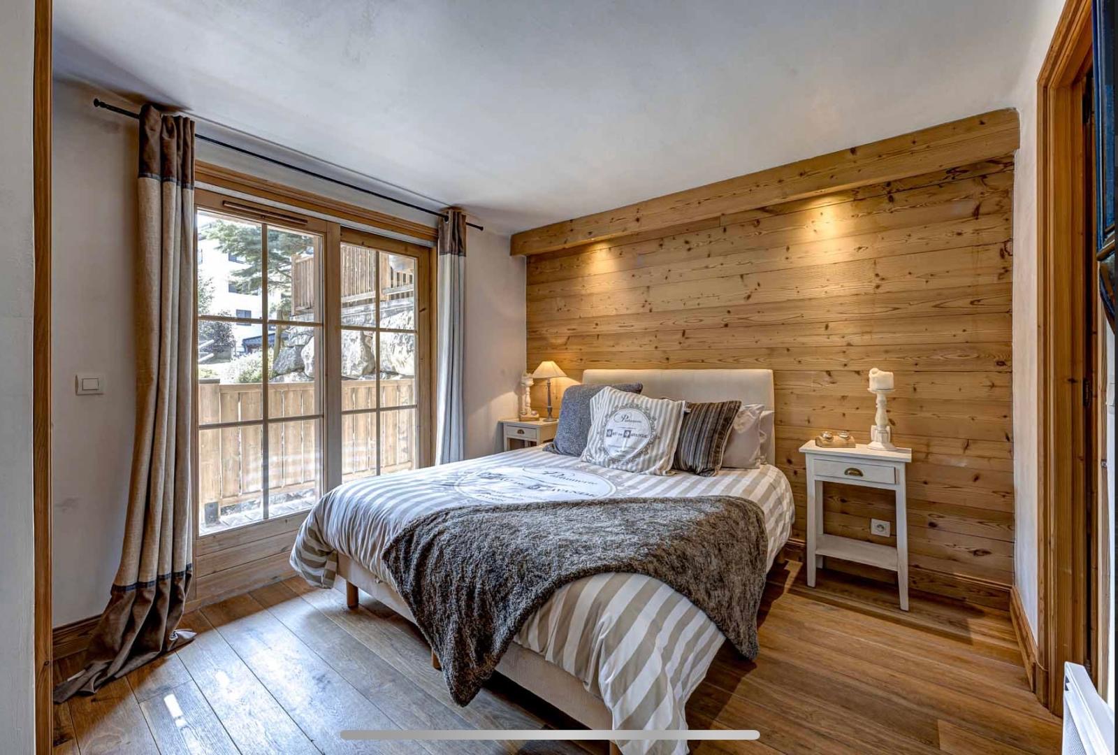 Bedroom with balcony doors onto the mountains